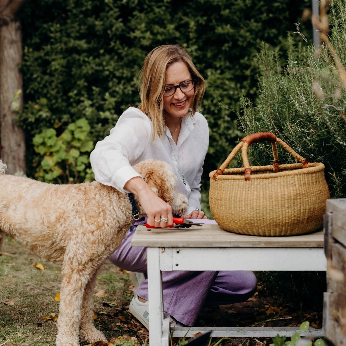 Hilary in garden with Fudge the dog